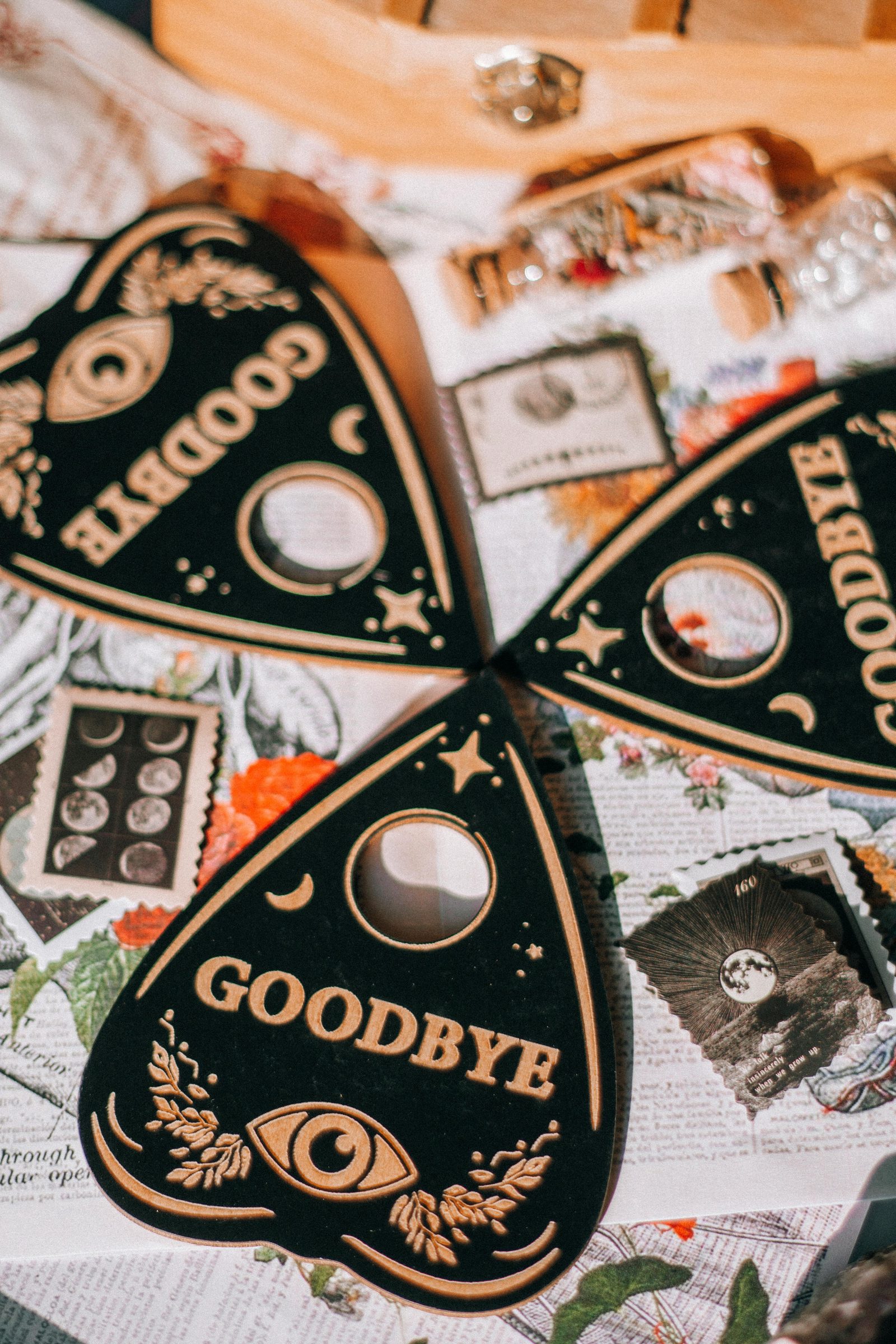 Close-up of planchettes on a spirit board spelling goodbye.